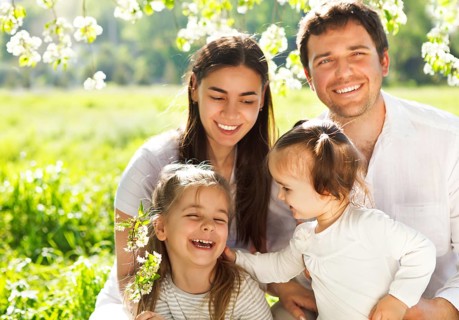 Happy young family with two children outdoors. Spring day
