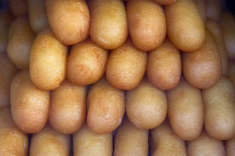 Indian sweet rolls like European rum cake sprinkled with coconut