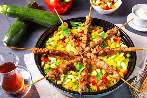 Lamb kebabs with curry rice and various vegetables
