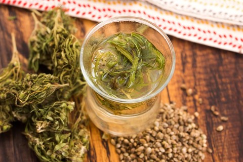 Cannabis herbal tea on wooden background