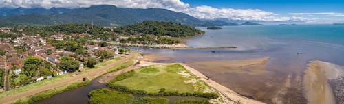 Panoramic aerial view to historic town Paraty, tidal river and Jabaquara with green mountains in