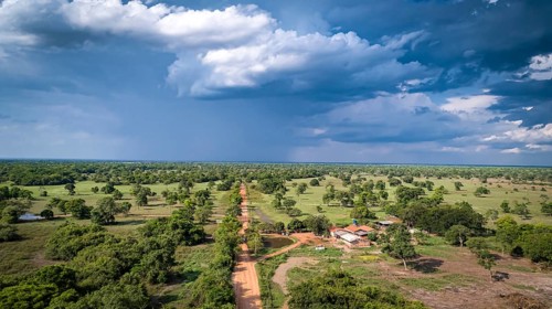 Aerial view of Transpantaneira dirt road with dramatic sky and rain crossing the typical landscape
