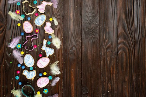 Sugar sprinkles, candies, feathers, cookie cutters, Easter frosted cookies in shape of egg chicken