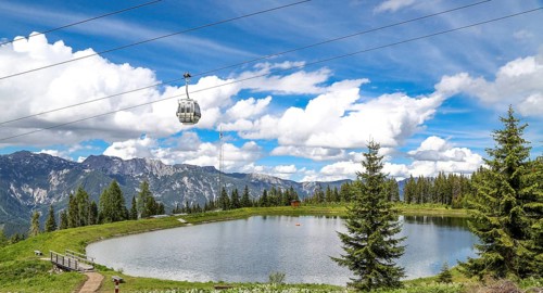 Small lake on the Planai with gondola lift. Smal water reservoir on a mountain by schladming,