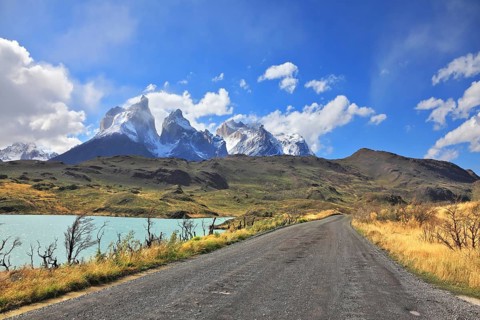 The gravel road along the shore of Lake Pehoe. The National Park Torres del Paine in Chile. In the