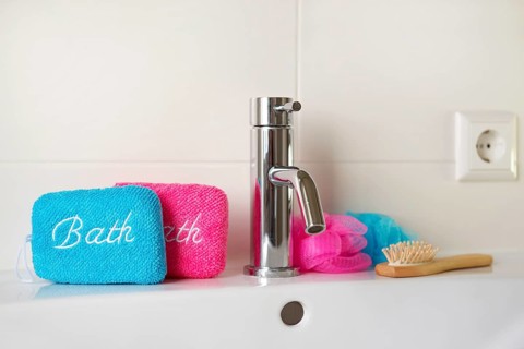 Bathroom with blue and pink sponges on sink