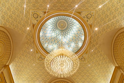 A picture of a chandelier in the ceiling of Qasr Al Watan