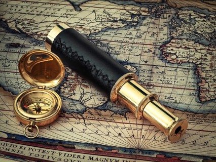 Traveling theme: vintage telescope and compass at antique (17 century) map