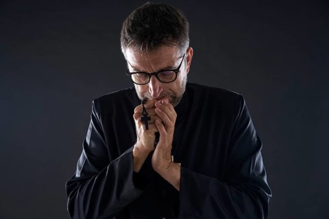 Priest praying hands with rosary beads male