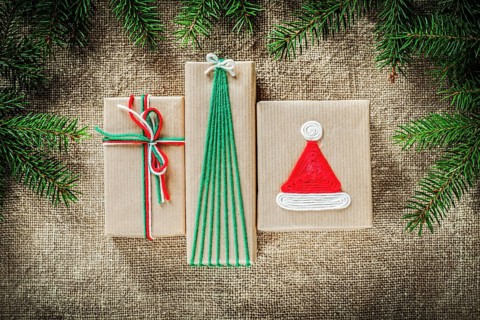 Set of fir tree branches handmade gift boxes on burlap background
