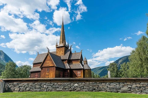 Lom stave church (Lom stavkyrkje) with graveyard foreground, Lom, Norway, Europe