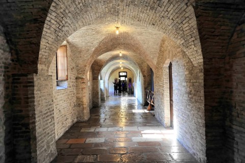 Basilica Santa Maria degli Angeli, Assisi, Umbria, Italy, A long vaulted corridor with brick walls