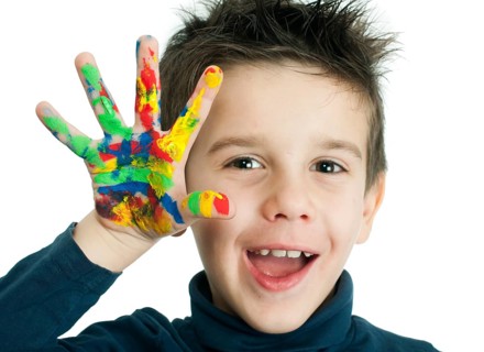 Boy hands painted with colorful paint. White islated smiling child
