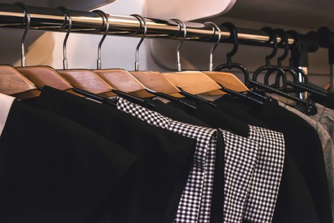 Clothes on hangers in shop. Close up