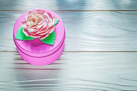Round pink present box on wooden board celebrations concept