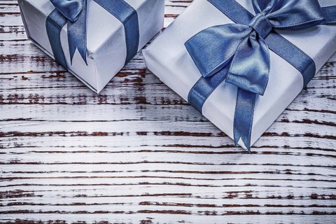 Packed giftboxes on vintage wood board holidays concept