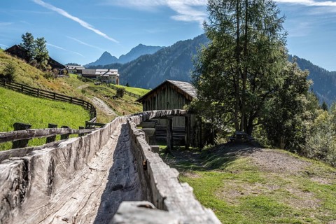 An old wooden inlet channel of a watermill in Val di Morins, the Dolomite Alps of South Tirol