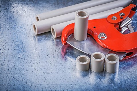 Set of pipe coupling tools on metallic background construction concept