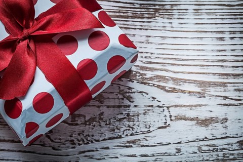 Present box on vintage wooden board celebrations concept