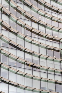 Abstract mosaic of geometric shapes adorns the modern building's facade, doubling as a captivating