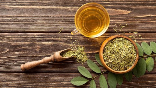 Flat lay green leaves cup tea