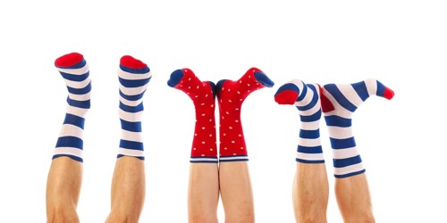 Feet in striped and dotted socks isolated over white background