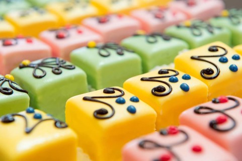 Many colorful petit fours with marzipan and chocolate