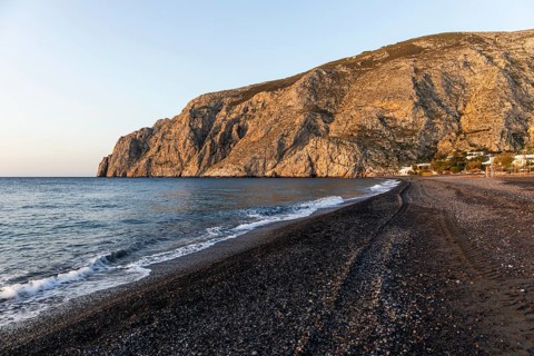Morning atmosphere, rocky cape Mesa Vouno, lava beach Kamari Beach, Santorini, Cyclades, Greece,