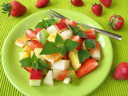 Fruit plate decorated with honeydew melon and sage