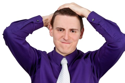Young man with shirt and tie ruffling his hair - optional