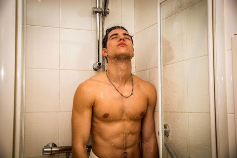 Close up Attractive Young Bare Muscular Young Man Taking Shower, Looking Down