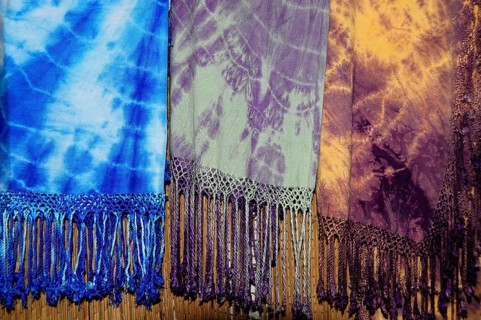 Fes, Northern Morocco, Morocco, Africa, Colourful batik scarves with fringes in blue, purple and