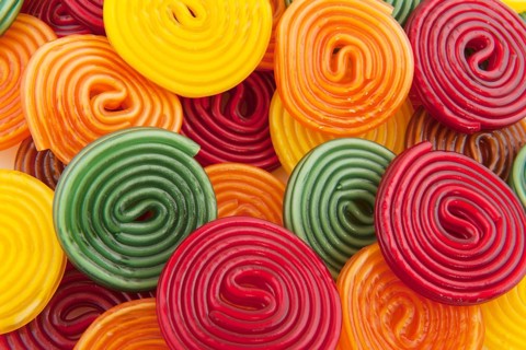 Colorful licorice candy drop rolls as background