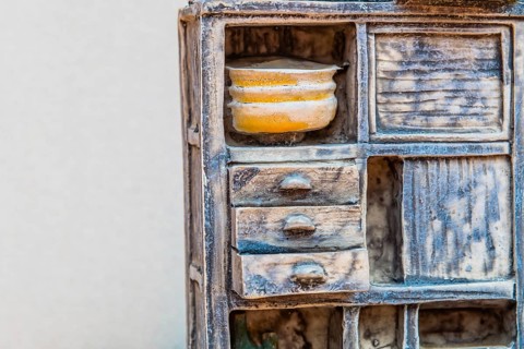 Gongju, South Korea, August 5, 2019: Closeup of miniature piece of kitchen furniture against white