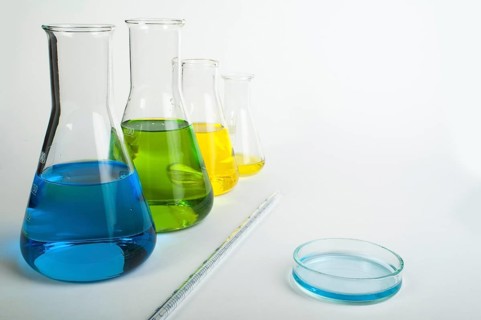 Laboratory glassware equipment. Laboratory beakers filled with colored liquid substances
