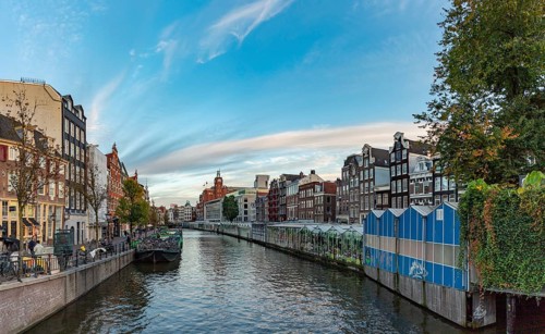 A picture of the Singel Canal and the Bloemenmarkt (flower market) of Amsterdam, at sunset