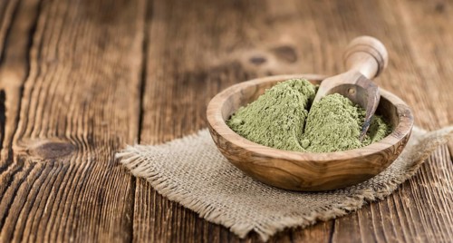 Stevia leaf powder (detailed close-up shot) on rustic wooden background