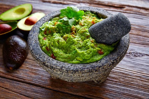 Avocado Guacamole on molcajete real Mexican traditional procedure