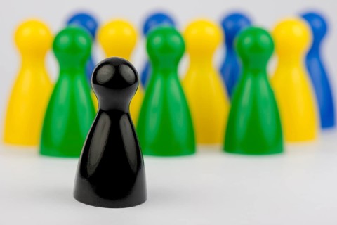 Conceptual game pawns that depict the concept different