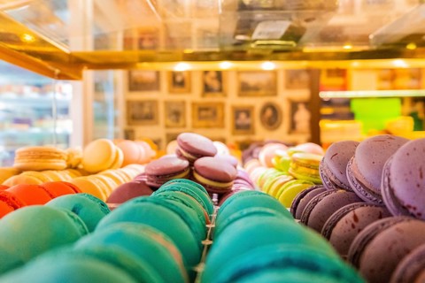 Close-up of macarons cakes of different colors in a patisserie. Culinary and cooking concept. Tasty