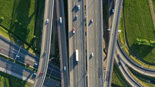 Aerial top view of lot of cars on modern road junction