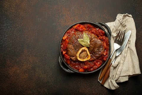 Traditional Italian dish Ossobuco all Milanese made with cut veal shank meat with vegetable tomato