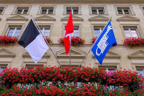 City Hall with Flag and Flowers in a Sunny Summer Day in City of Fribourg, Canton Fribourg,