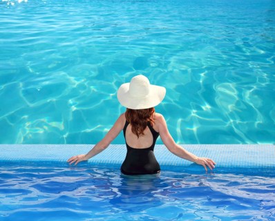 Caribbean tropical sea view from blue pool rear woman beach hat