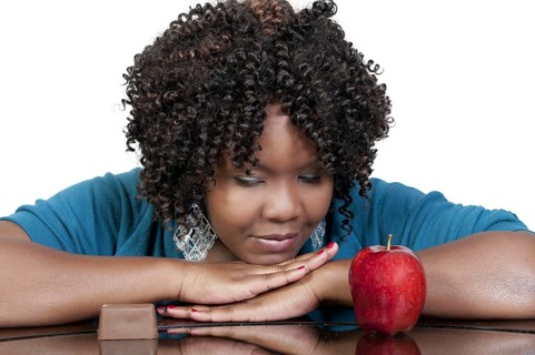 A woman trying to decide whether or not to eat healthy