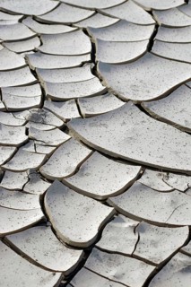 The top view and close-up of a dried out and fragmented layer of soil