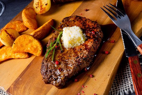 Butter beef steak with herbs and potato wedges