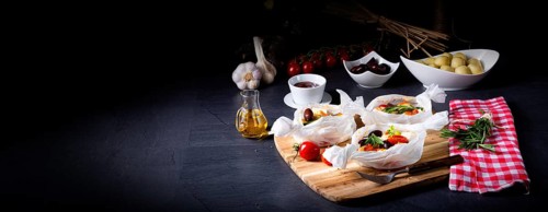 Baked dumplings with courgette, tomatoes and diced sheep's cheese