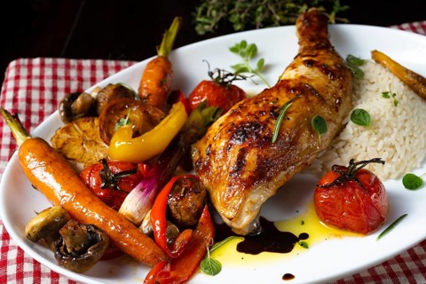 Rustic fried chicken legs with assorted vegetables and rice