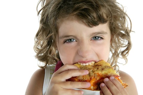 Little girl eating hungry pizza closeup portrait face detail wite background